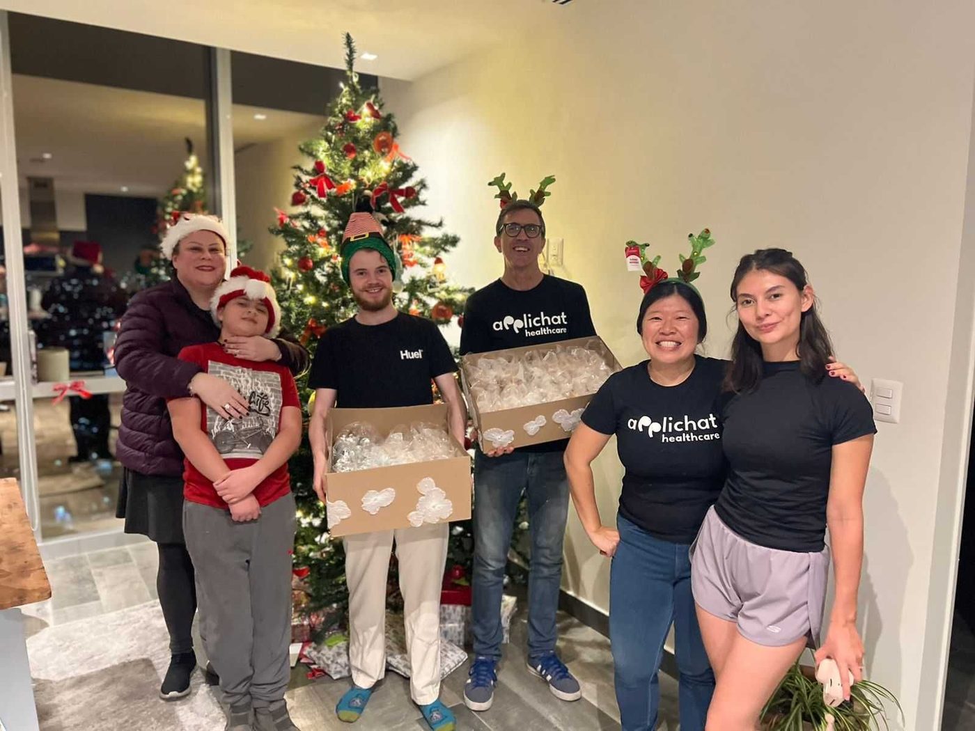 The Applichat healthcare team wrapping gifts during the holidays.